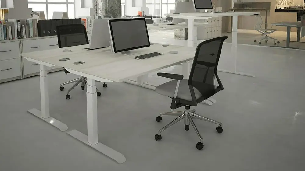 White height-adjustable desks with mesh chairs